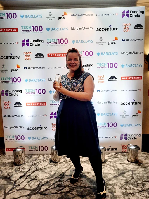 Female stood with award