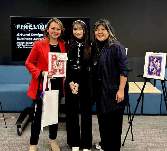 Image of three woman standing together with art in the background including Minister Valdez wearing a red coat and President Serrano in black.