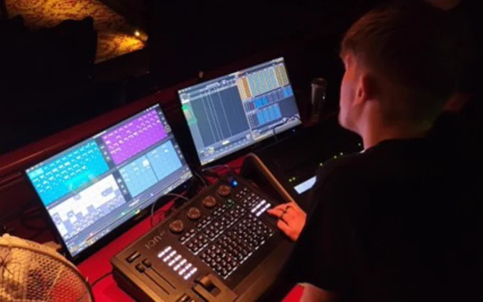 A student at a lighting desk at City Varieties