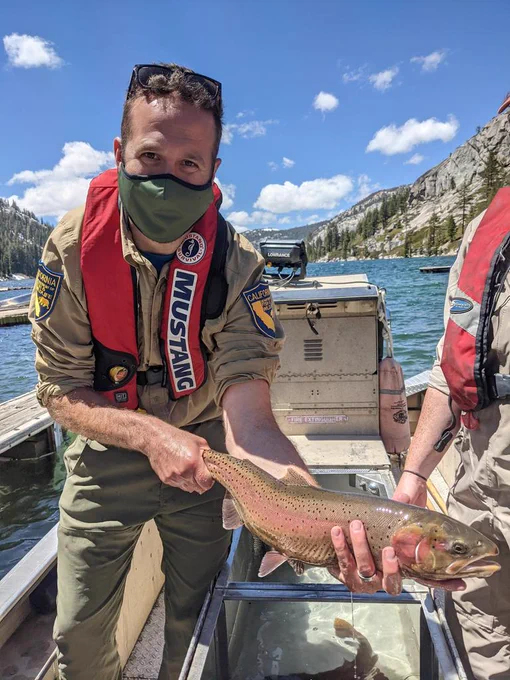 Me, in a boat,  holding a Lahontan Cutthroat Trout
