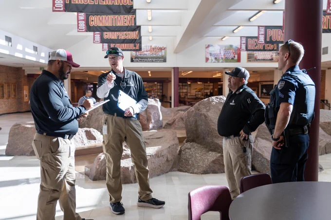 PSD staff and law enforcement officers work and talk together at Rocky Mountain High School.
