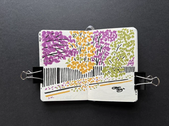 Sketchbook spread with brush pen ink illustration — fence going into perspective and trees with purple, ochre and green leaves. Bike lane sign on the ground.