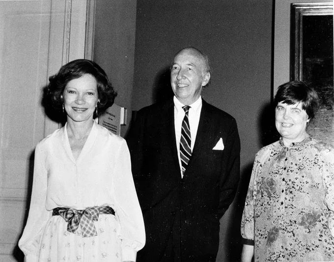 Black and white photo. On left, Rosalynn Carter. In center, Secretary of Smithsonian. On right, Smithsonian curator. All smile.