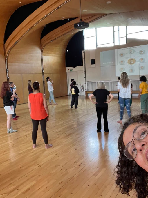 A group of people participating in a movement workshop