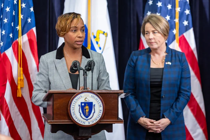 AG Campbell at podium with Governor Healey behind her. 