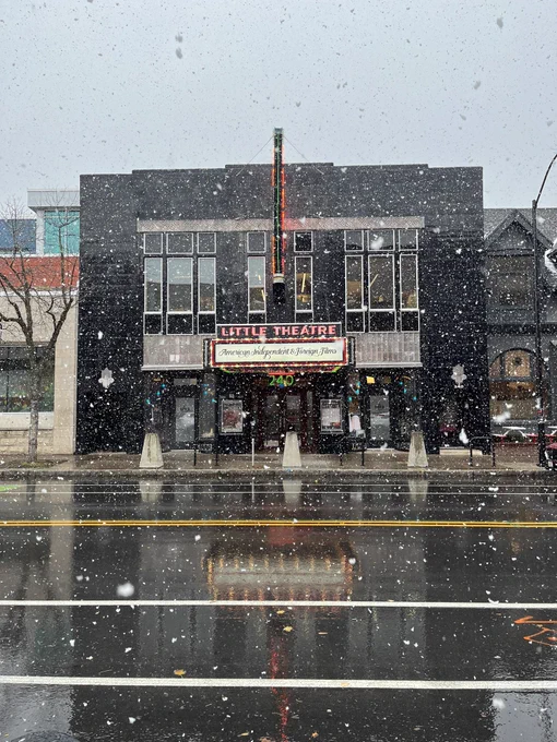 Snow falling outside a movie theatre