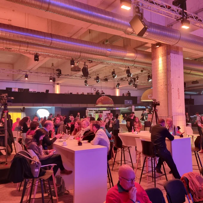 Photo of the event showing many of the participants in conversation.