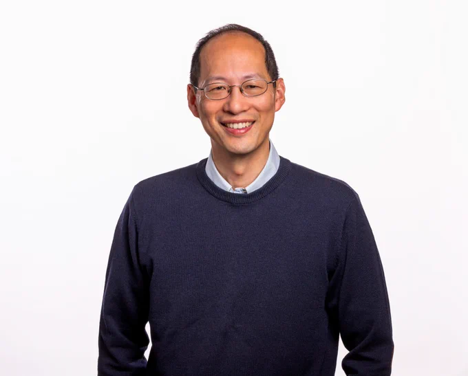 Color portrait of P.I. Christopher Chang, against a white background.