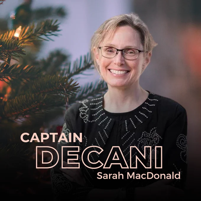 Sarah MacDonald standing in front of a Christmas tree