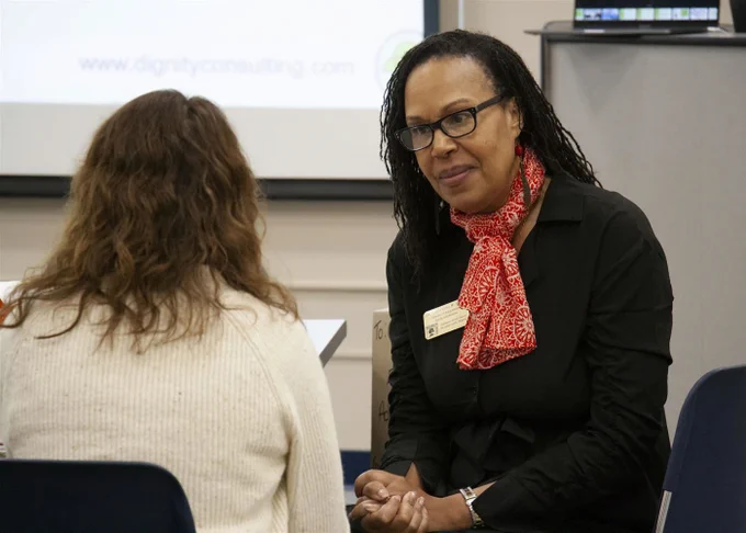 A Rockwood administrator engages with a colleague during a training session. 