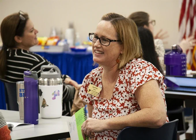 A Rockwood staff member smiles while engaging with a colleague during a training session. 