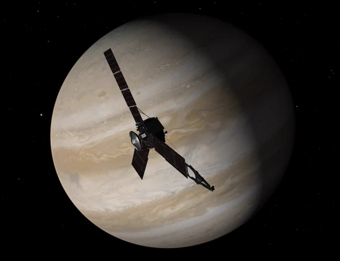 Simulated view of the Juno spacecraft silhouetted by Jupiter in the background. Juno has a central body and three large solar panel arrays that radiate like a fan. Jupiter's colorful stripes and swirling storms can be seen in its atmosphere. 
