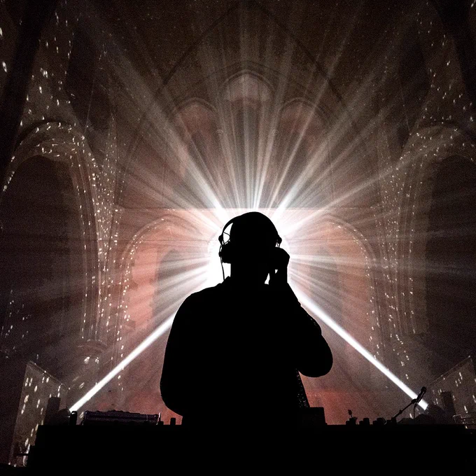 A DJ performs a set on stage
