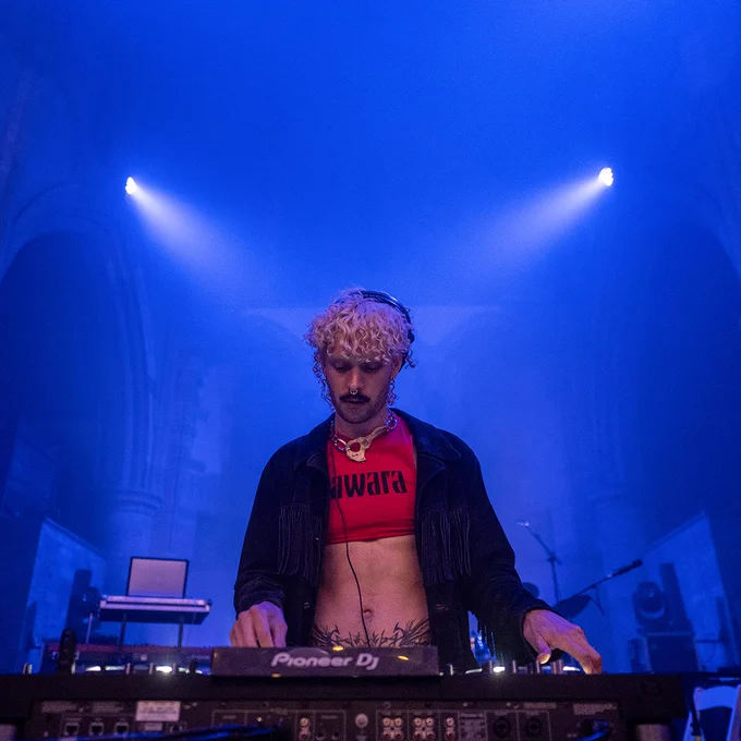 A DJ performs a set on stage