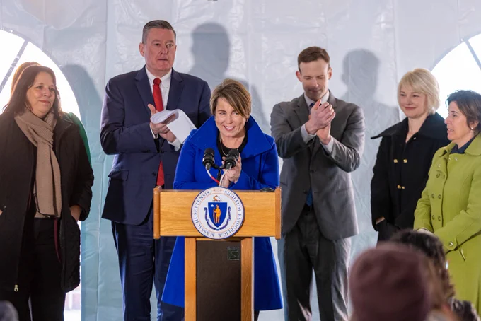 Governor Healey smiling at podium.