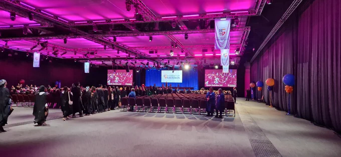 Graduation ceremony taking place in an exhibition centre