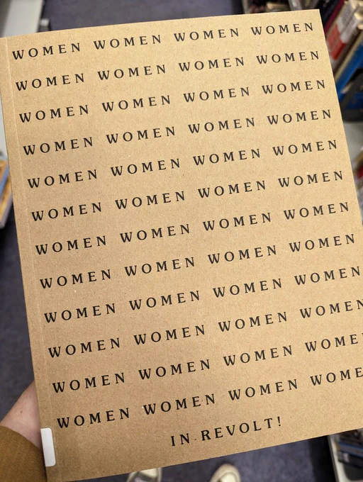 Book cover of the catalogue with the word 'Women' written across it numerous times and then at the bottom it says 'In Revolt!'