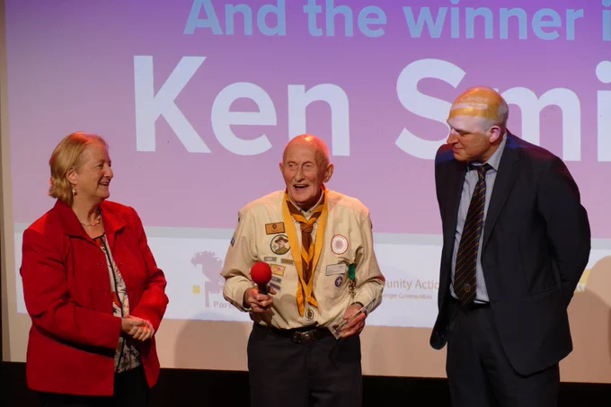 The Leader of Sutton Council, Councillor Ruth Dombey and Tim Vine standing with the winner of Sutton Community Awards Lifetime Achievement Award, Ken Smith.