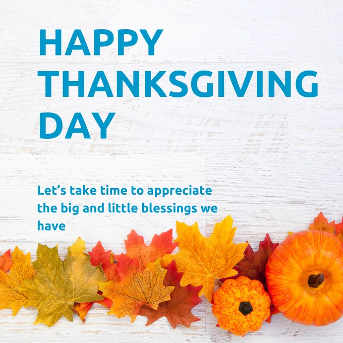 Thanksgiving greeting with the words 'Happy Thanksgiving Day' in bold blue letters, followed by a message of appreciation on a white wooden background, adorned with colorful autumn leaves and pumpkins