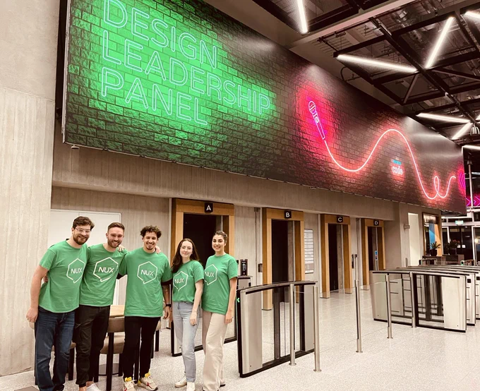 NIX volunteers at Codes HQ after our latest design meetup. Volunteer group posing in front of NUX signage.