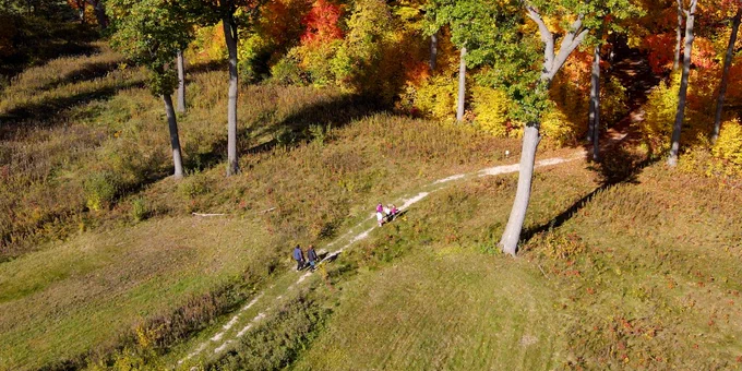 An aerial view of four people hiking along a trail at Lizard Mound State Park. 