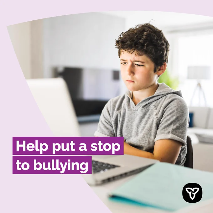 An anxious student reading something on his laptop computer. Title: Help put a stop to bullying 