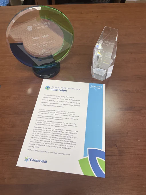 Picture of two awards and the award writeup recognizing a clinician for her work with adaptive gaming.