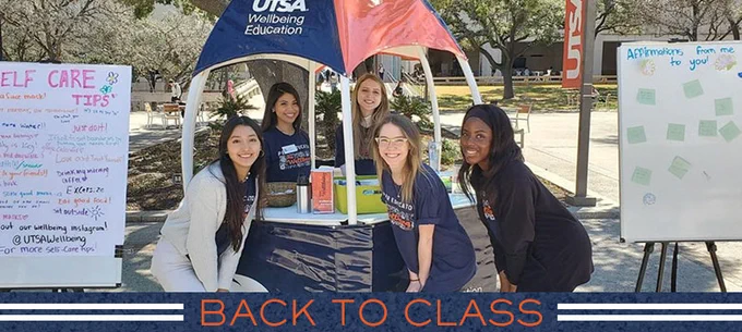Wellbeing services smiles at the camera during one of their popups on campus. 