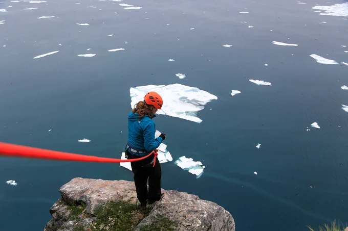 Me examining murre nests with sea ice in the background