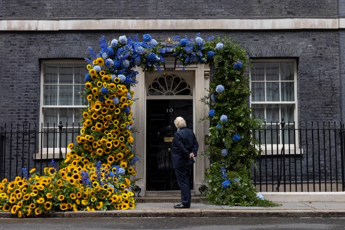 Prime Minister Boris Johnson observing sunflower arch on 10 Downing Street.