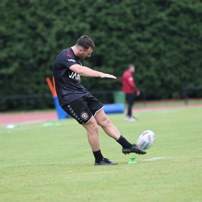 Harry Smith practicing his kicking.