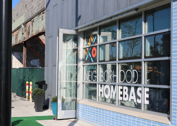 A building that says Live6 Alliance Neighborhood HomeBase is seen outdoors.