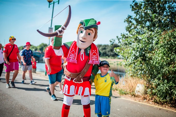 Robin Hood poses with a young Forest supporter ahead of this afternoon's fixture.