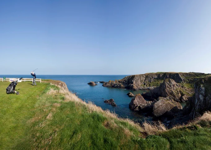 Image shows golfer attempting to play a shot over the cliffs at the 6th hole at Eyemouth Golf Club, Scottish Borders - voted Britain s No1 Most Extraordinary Golf Hole, known as A Still No Ken (I Still Don t Know)