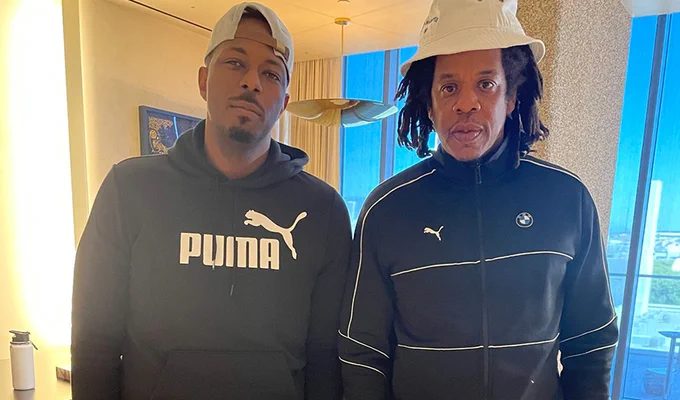 Michael J. Payton and Jay-Z stand next to each other indoors