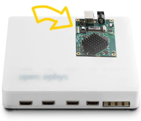 Classic Open Ephys Acquisition Board with an arrow pointing to the FPGA (Field-Programmable Gate Array) module inside it.