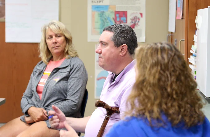 three teachers sharing information in a classroom