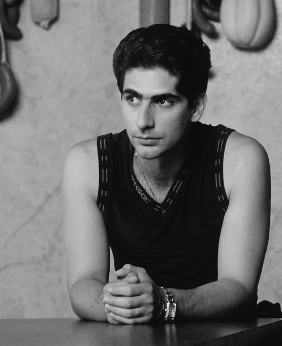 a photo portrait of christopher moltisanti (actor michael imperioli) from the sopranos, wearing a sleeveless shirt, looking off into the distance