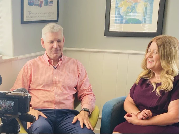 Craig and Anne side by side on interview set laughing