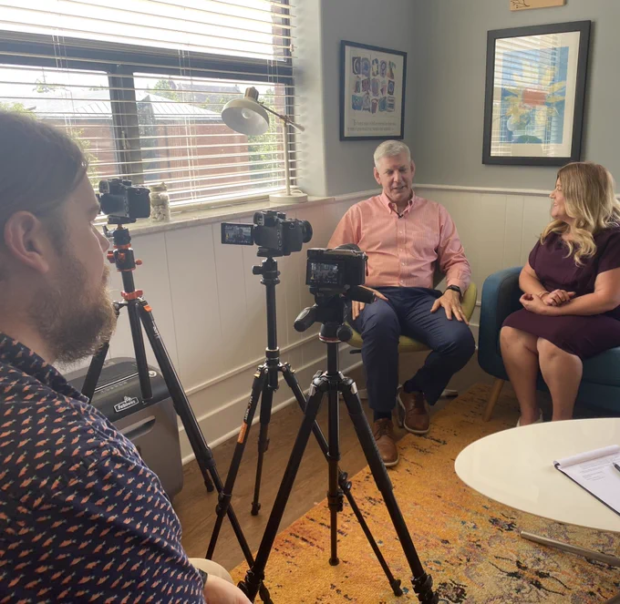 Craig and Anne on interview set with 3 cameras, Ricky in the foreground observing