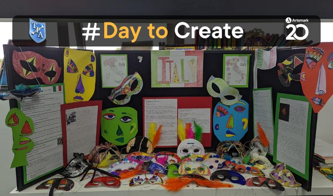 The Premier Academy, their #DayToCreate creations. On a table and on a black cardboard, there are masks made by students and writing on the board.