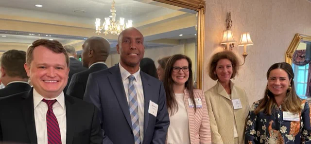BJA Director Karhlton F. Moore stands with Office of Justice Programs Principal Deputy Assistant Attorney General Amy Solomon, and others at the Institute for State Criminal Justice and Public Safety Executives, where attendees coordinated policy development and criminal justice planning to address public safety challenges.