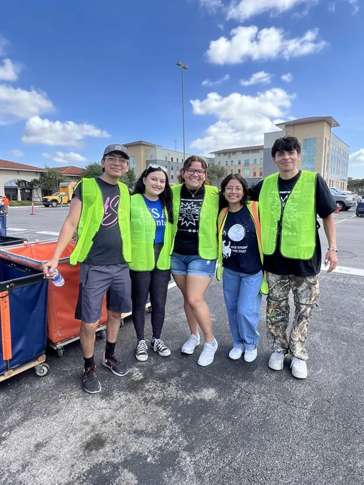 A group of volunteers with HSA smile at the camera.