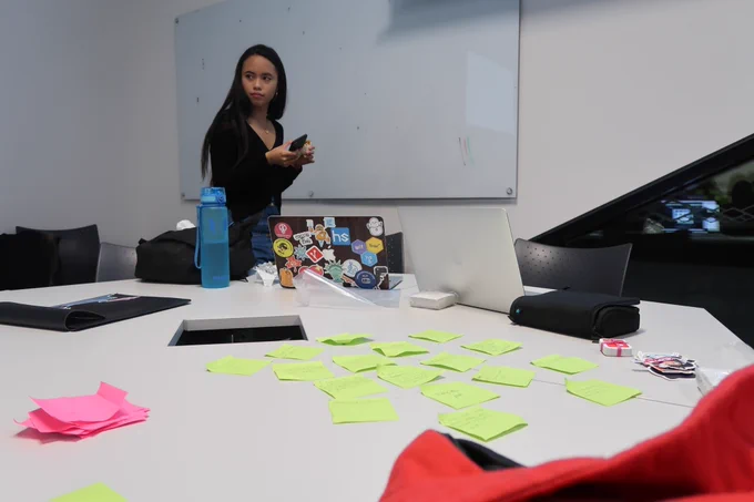 Teaching women how to code with Code First Girls in 2018, I laugh at this picture because I look so sneaky for no reason.