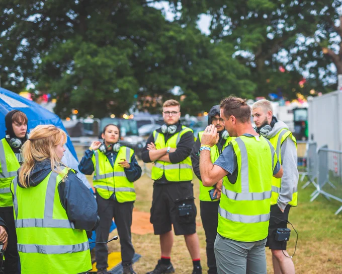 Solent Productions crew members gather around outside for a quick briefing.