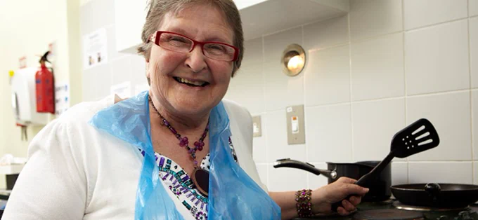 person smiling and cooking