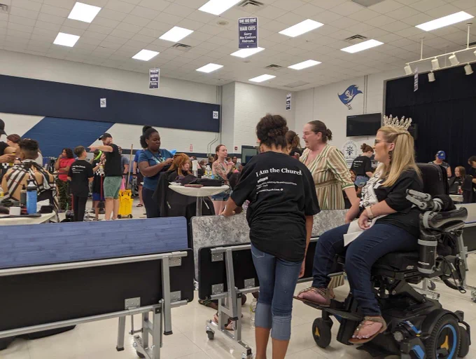 Sara talks to people during the Big Give