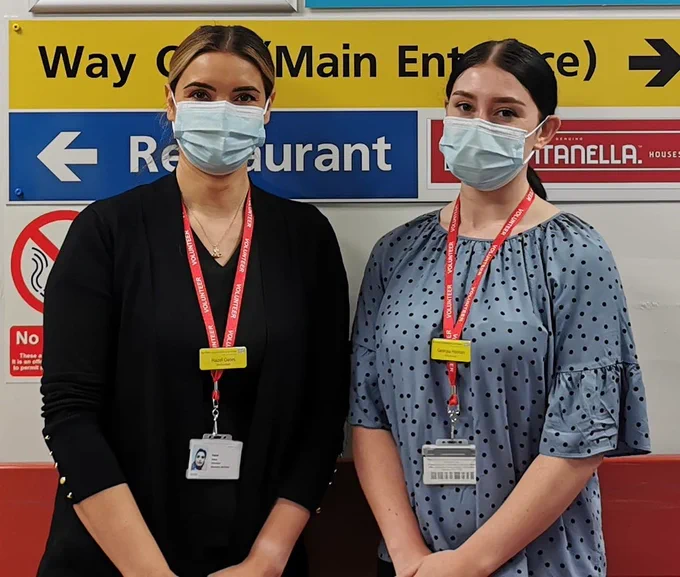 Two women stood in a hospital.
