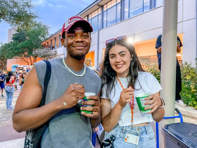 Two Roadrunners enjoy Kona Ice as they watch the Spirit of San Antonio.
