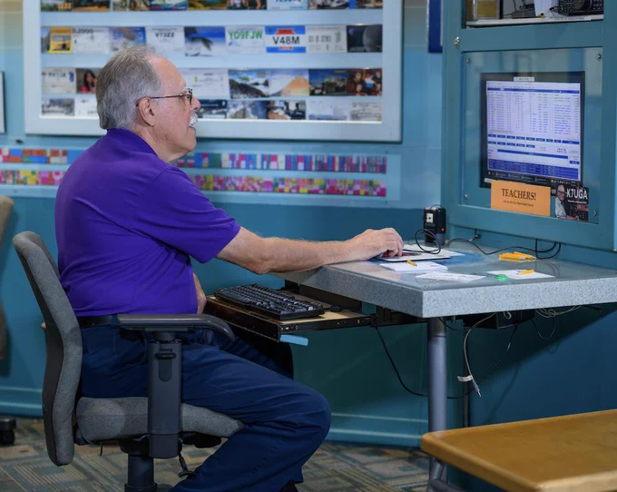 man sitting on a chair looking at computer screen